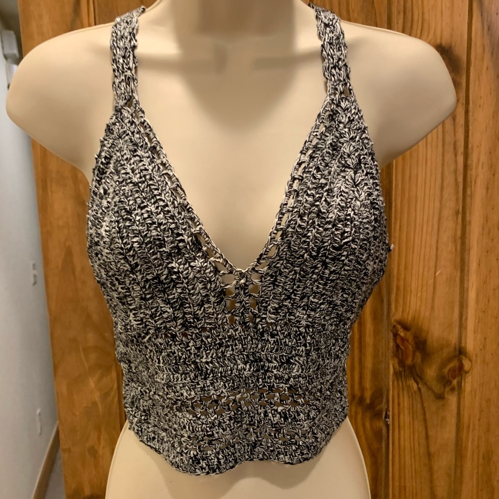 Knit crop top. Tie back closure.